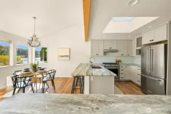 A view of the kitchen and breakfast nook from the formal dining/great room.