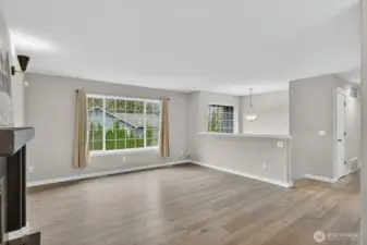 Spacious and light-filled living room featuring a cozy gas fireplace—the perfect spot to gather and unwind.