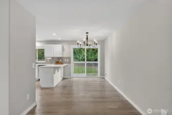 Comfortable dining space off the kitchen with sliding doors leading to the deck and backyard retreat.