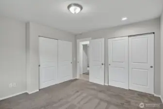 Spacious primary suite with dual closets and a private ensuite bath for a perfect personal retreat.