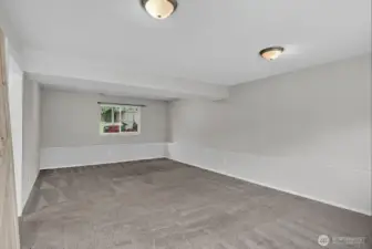 Expansive lower-level family room offering endless options—movie nights, home gym, play space, or office.