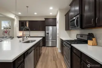 Clean bright quartz countertops and subway tile backsplash.
