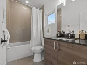 Secondary bathroom on the upper level! Model home.