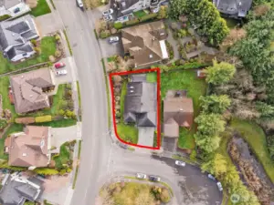 Aerial image outlining the property boundaries, showing lot shape, yard space, and street orientation.