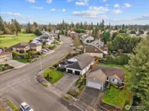 Aerial perspective showing the property in relation to nearby golf course and surrounding natural areas.