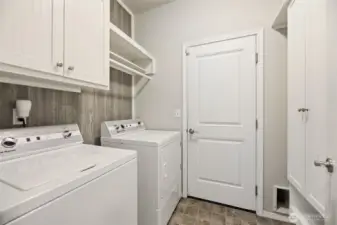 Laundry room off of the 3 car garage with custom cabinets