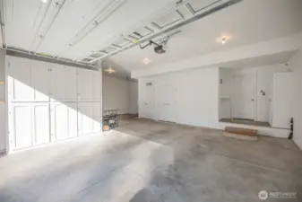3 car garage with custom cabinets for added storage.
