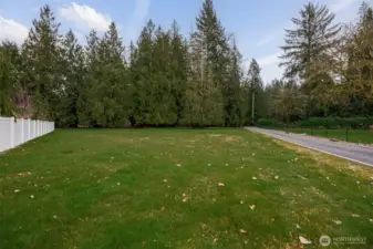 Property from the house goes all the way down to the white fence open field area