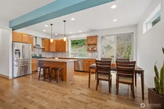 The kitchen and dining area are designed for everyday living with views to the outdoors and access to the patio.