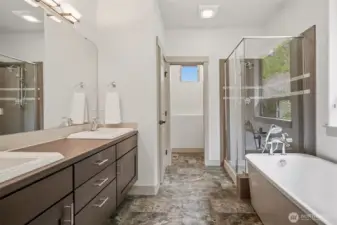 Spa-like bath with double vanity, soaking tub, and separate shower.