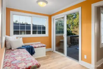 Just look at this cheery, bright room.  Located off the kitchen, it showcases built in benches and easy access to the deck and backyard.