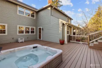 This deck area is located off the dining area between the home and the garage.    The hot tub and gas grill stay with the home!