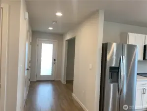 Front door and garage access. Coat Closet.