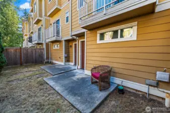 Outdoor patio, door exiting garage.
