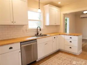 The well-designed kitchen area offers an open and inviting feel creating a seamless flow between the cooking and dining spaces.
