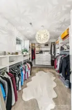 One of two walk in closet's in Primary with built in closet system