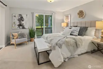 Spacious primary suite with slider to a small deck.