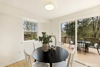 Eating nook off kitchen with view sliders to back deck.