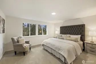 Primary bedroom with serene views of the backyard.