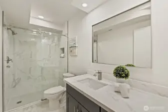 New bathroom added in the basement, including quartz counters and luxury tile shower with rolling glass farm door.