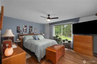 Primary bedroom featuring an ensuite bath with views of the property.