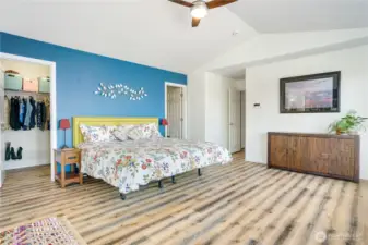 Expansive Primary Bedroom with a walk through closet behind the bed