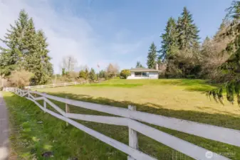 White board fence frames the setting for this lovely close-in mini-farm!