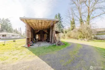 31'  X  14' covered parking for R/V.   Fruit trees and garden area nearby.
