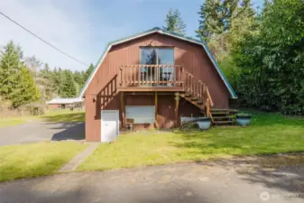 Exterior door to garage /workshop with upper sliding door to hay storage area.