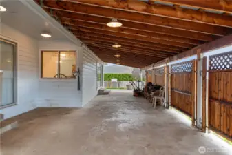 Huge Covered Patio Runs Length of West Side of Home