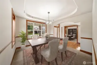 The Dining Room is open & bright featuring beautiful wood trim and coffered ceiling. (Virtual staging).