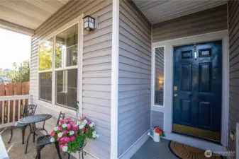 The front entry greets you with covered porch and entry door.