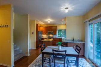 Looking from the family room to the kitchen, you see the slider out to the large patio and fenced back yard.