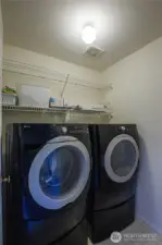 The laundry room is located on the upper floor conveniently near the bedrooms, and the washer and dryer are included in the sale.