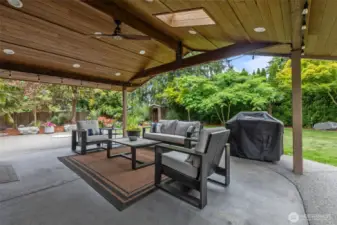 Your private backyard oasis awaits. Enjoy a huge covered patio for entertaining and stunning landscaping with built-in fire pit, water feature, and a ton of lush native and non-native plants! Two generously sized outbuildings provide ample additional storage