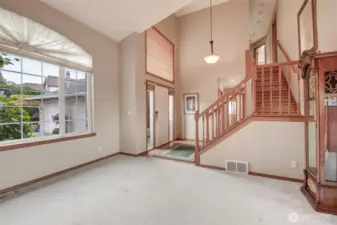You will note all of the natural lighting in this entry, beautiful staircase and the meticulous hardwood floors.
