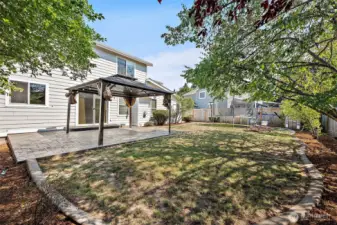 Decorative Curbed Lawn. Mature Trees for added privacy in the fulled fenced backyard.