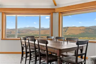 Spacious dining area framed by large windows—meals with a view. Valance lighting, highlights the vaulted ceiling.