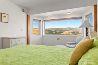 Inviting guest bedroom offers comfort and privacy and expansive views.