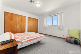 Bright third bedroom with abundant natural light and serene views that stretch north toward Canada.