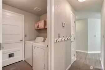 Laundry room leads to the garage and additional storage.