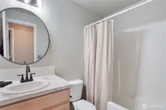 Hall bathroom has updated countertops and fixtures.