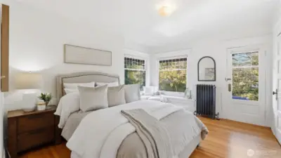 1 of 4 upstairs bedrooms. Southwest facing with the sweetest window seat, walk in closet & deck shared with the adjacent bedroom.