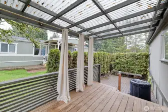 Expansive back deck ideal for entertaining, complemented by an adjacent patio area