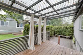 Expansive back deck ideal for entertaining, complemented by an adjacent patio area