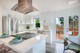 French doors lead to the oversized deck and entertainers backyard