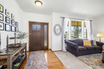 Open entrance with gorgeous hardwood floors and new carpets