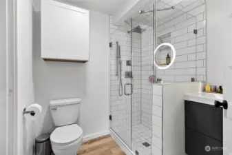 Full bathroom remodel with quartz countertops, light fixtures and custom tiled shower.
