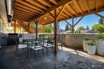 Enjoy BBQing and dining in the covered large covered patio area off kitchen. (Virtually staged)