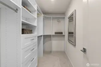 Maximize organization with this custom-designed walk-in closet. Its built-in shelving and ample hanging space ensure that everything has its place, offering a blend of practicality and elegance.